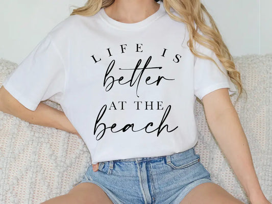 a woman sitting on a couch wearing a t - shirt that says life is better