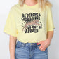 a woman wearing a yellow shirt that says be strong and courageous