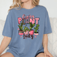 A woman wearing a blue t-shirt with a graphic design featuring various potted plants and the text "Crazy Plant Lady".