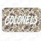 A rectangular object with a camouflage pattern and the word "COLONELS" written in a bold, white font.