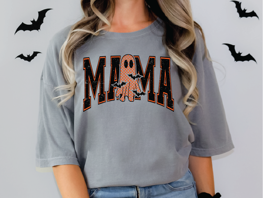 A woman wearing a grey t-shirt with the word "MAMA" printed on it, along with a ghost design.
