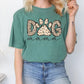 a woman wearing a green dog mama t - shirt