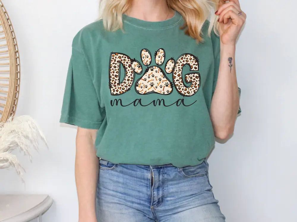 a woman wearing a green dog mama t - shirt