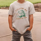 a young boy wearing a t - shirt that says follow me