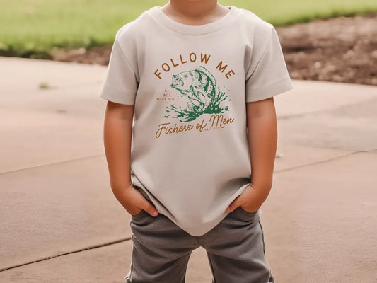 a young boy wearing a t - shirt that says follow me