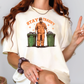 a woman wearing a t - shirt with a picture of a man holding a peace