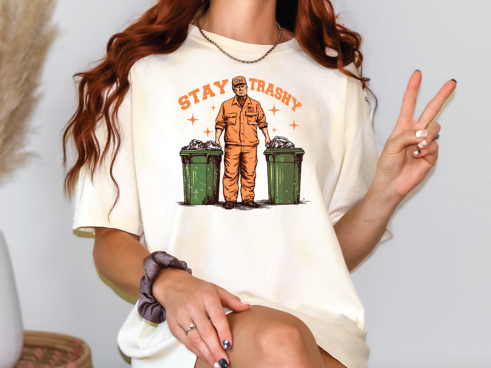 a woman wearing a t - shirt with a picture of a man holding a peace