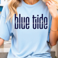 A woman wearing a light blue t-shirt with the text "blue tide" printed on it.