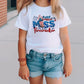 a little girl wearing a white shirt and jean shorts