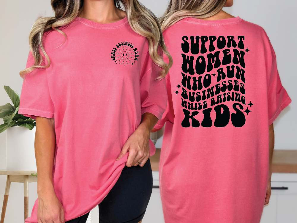 two women wearing pink shirts with black lettering