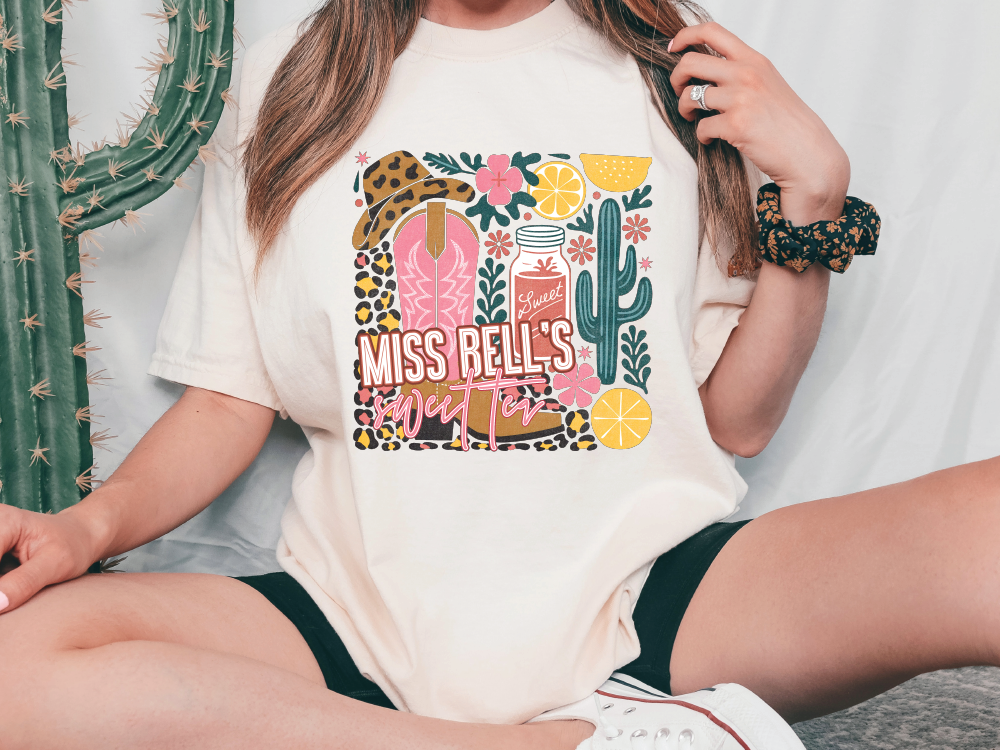 a woman wearing a t - shirt that says miss bells