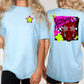 two different views of a woman wearing a light blue t-shirt with a graphic design on the back.