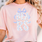 A woman wearing a pink t-shirt with the word "BEARS" printed on it.