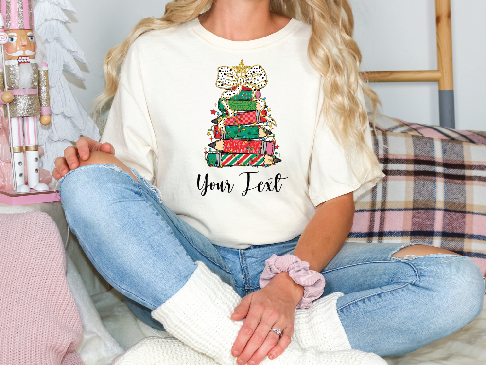 a woman sitting on a couch wearing a t - shirt with a christmas tree on