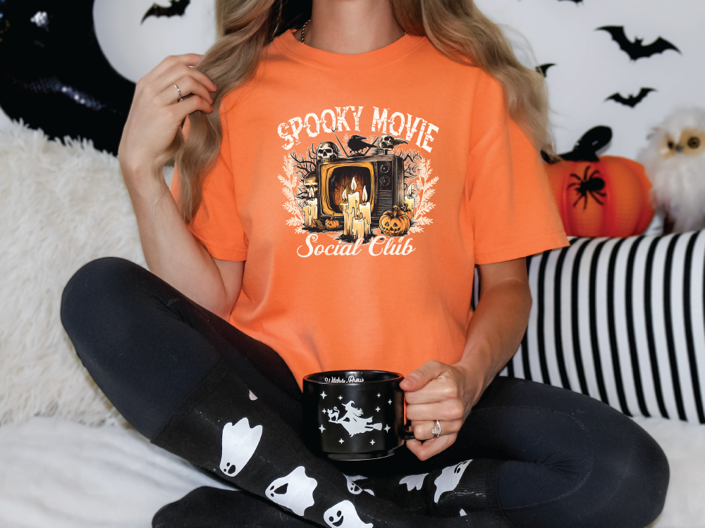 a woman sitting on a bed holding a coffee mug