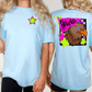 two women wearing light blue t-shirts with colorful designs on the back.