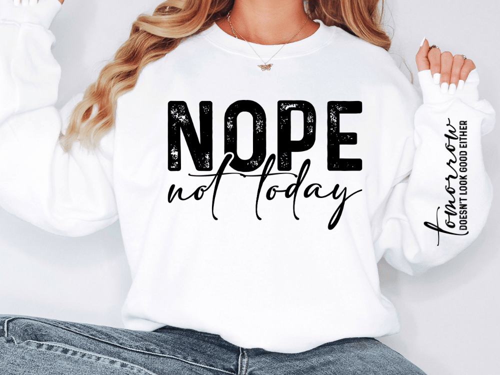 A person wearing a white sweatshirt with the text "NOPE not today" printed on it.