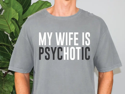 a man wearing a grey t - shirt that says my wife is psychic