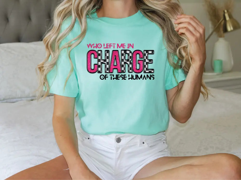 a woman sitting on a bed wearing a t - shirt that says change of three