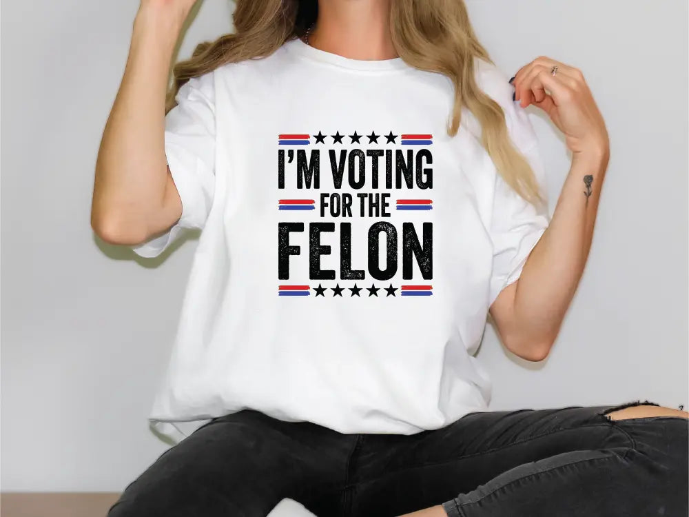 a woman wearing a t - shirt that says i'm voting for the fe