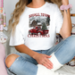 a woman sitting on a couch wearing a t - shirt with a red truck on