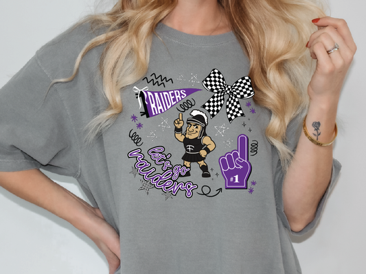 A person wearing a grey t-shirt with a graphic design featuring a character and text related to the word "RAIDERS".