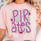 A woman wearing a pink t-shirt with the text "PIRATES" printed on it.
