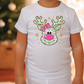 a little girl wearing a white shirt with a reindeer head on it