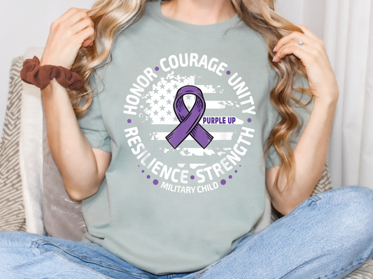a woman wearing a t - shirt with a purple ribbon on it
