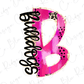 A pink and black design resembling a stylized letter "B" with various decorative elements such as polka dots and leopard print patterns.