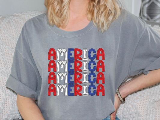 a woman sitting on a couch wearing a t - shirt that says america