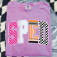 A pink t-shirt with the word "SPED" printed on it, along with a graphic design that includes a pencil and a checkered pattern.