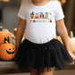 a little girl wearing a white shirt and black skirt