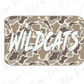 A camouflage-patterned sticker or decal with the word "WILDCATS" written in bold, white letters.