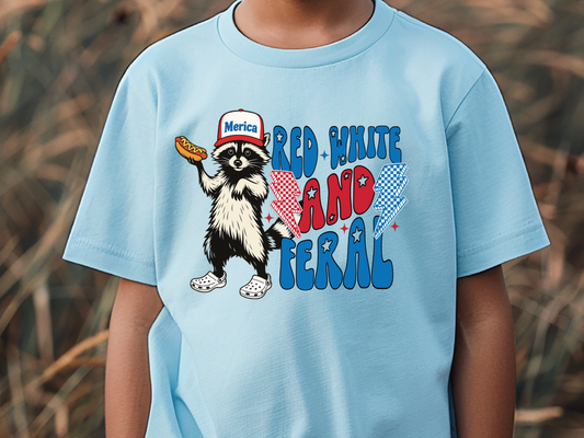 a young boy wearing a blue shirt with a cat in the hat on it