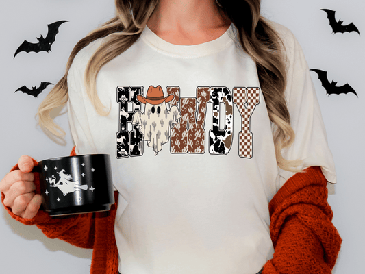 A person wearing a white t-shirt with the word "HANDY" printed on it, holding a black mug with a ghost and a cowboy hat design.