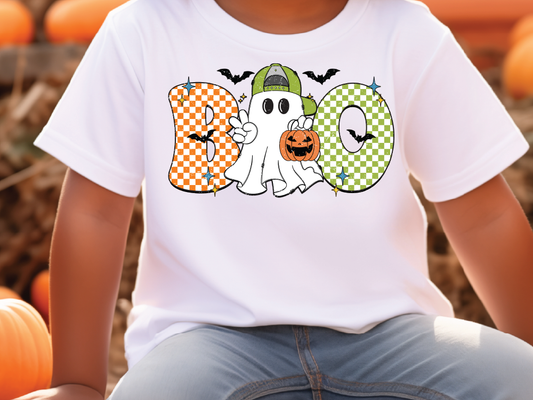 A white t-shirt with a graphic design featuring a ghost character and Halloween-themed elements, such as a pumpkin and bats.