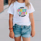 a little girl wearing a white shirt and jean shorts