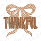 a leopard print bow with the word "THANKFUL" written on it.