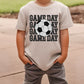 a young boy wearing a t - shirt with a soccer ball on it