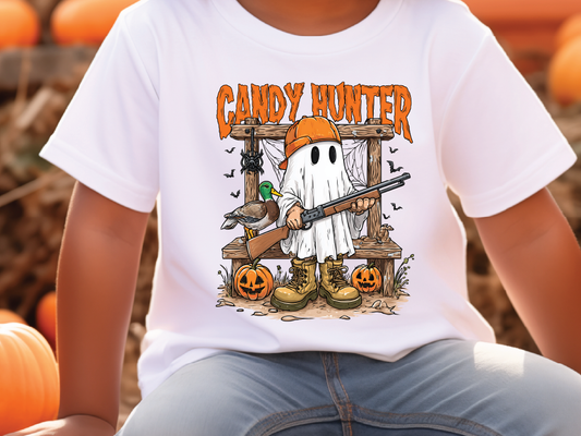 A white t-shirt with a graphic design depicting a ghost holding a gun and a bird, with the text "CANDY HUNTER" above the image.