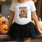 a little girl wearing a mickey mouse shirt