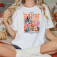 a woman sitting on a bed holding onto a harvest t - shirt