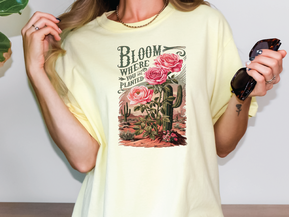 a woman wearing a t - shirt with a cactus and flowers on it