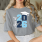 A woman wearing a gray t-shirt with a graphic design that says "Class of 26" and a graduation cap.