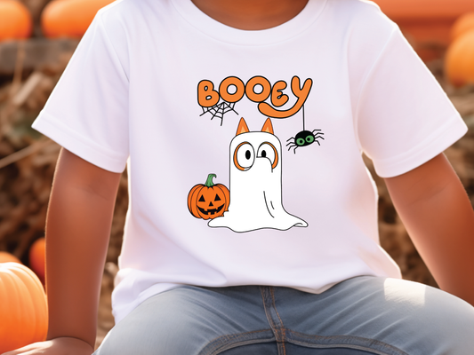 a young boy wearing a booy halloween t - shirt