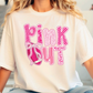 A person wearing a white t-shirt with the text "PINK OUT" printed on it.