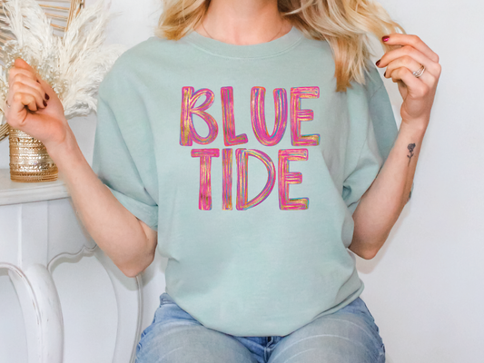 a blonde woman wearing a blue t - shirt with the words blue tide on it