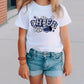 a little girl standing on a sidewalk with a skateboard