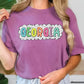 a woman wearing a purple shirt with the word georgia on it